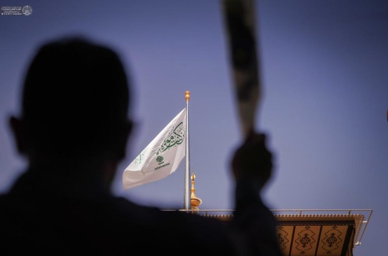 Izamiento de la bandera de Ghadir sobre la cúpula del Santuario del Imam Alí durante el inicio de la Semana Internacional de Ghadir en Nayaf.